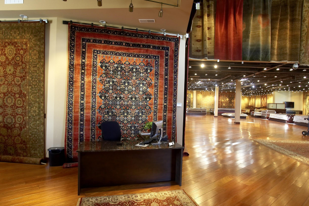 Interior of the Cyrus Artisan Rugs showroom with area rugs on display