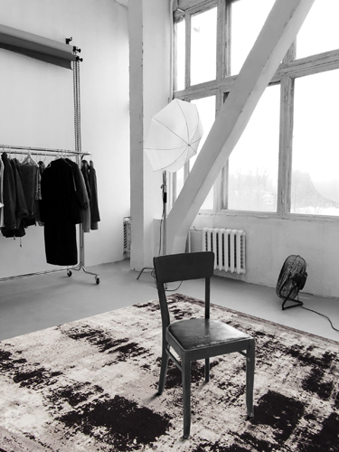 living room with gray sofa and black and white rug