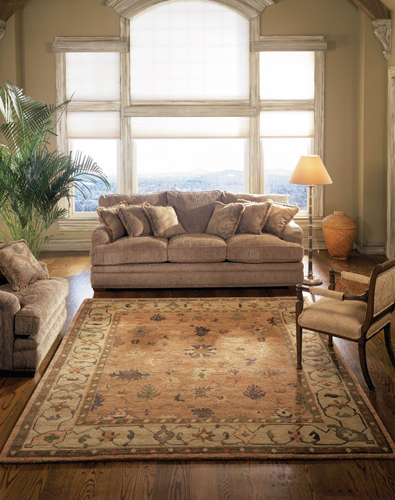 light colored tribal area rug placed in an airy living room