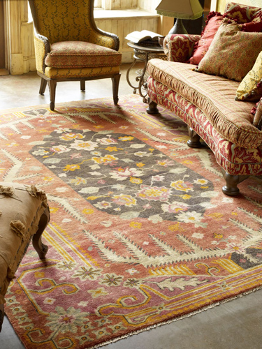 large area rug placed below elaborate furniture pieces