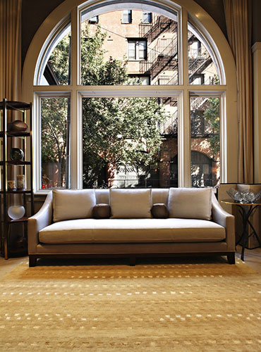 bright living room with arched window