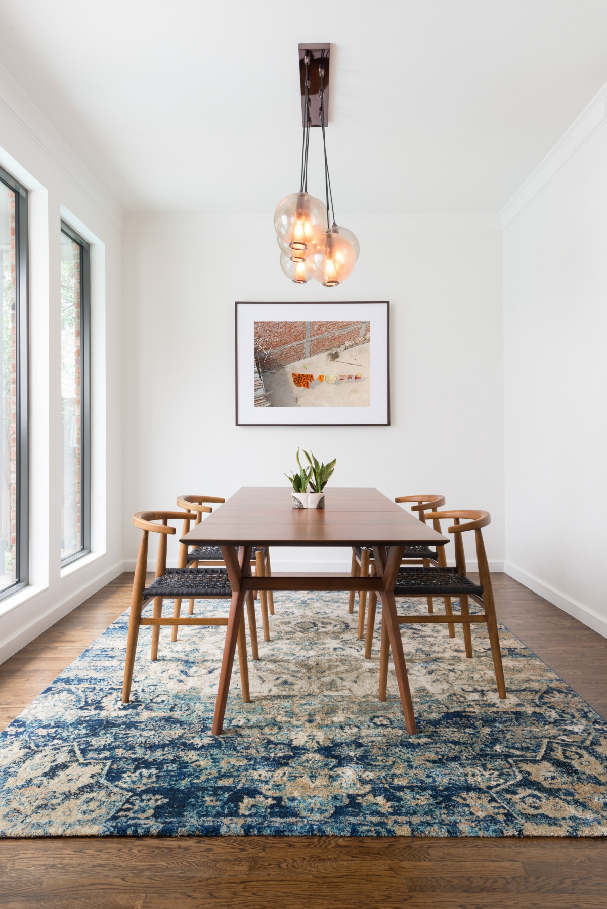 bohemian-scandinavian dining room with statement lights