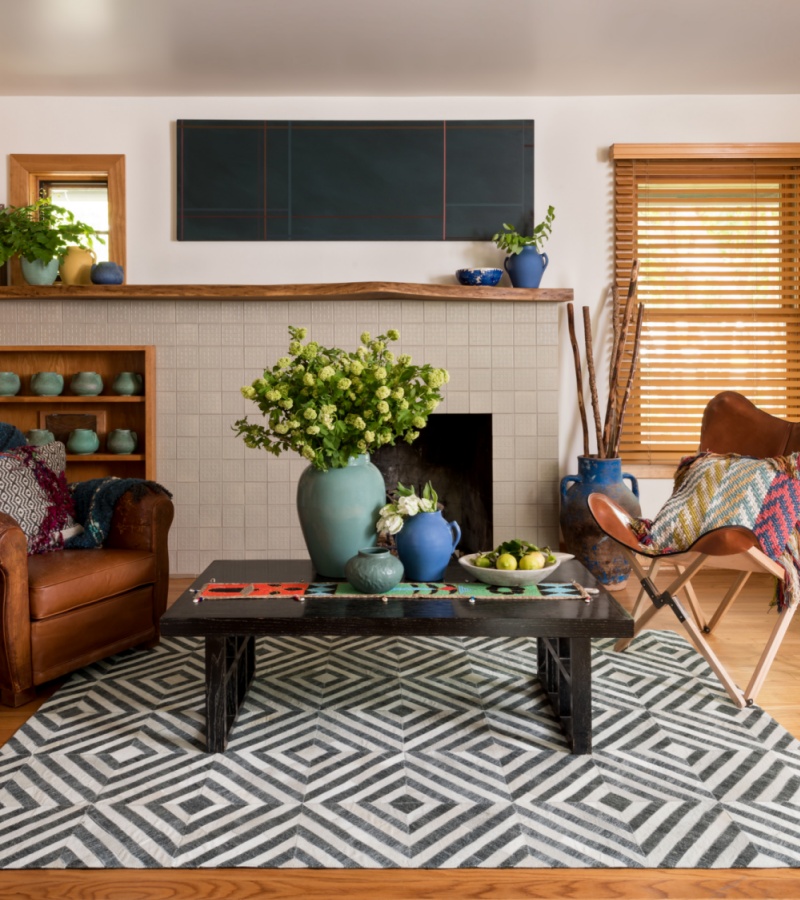 leather chairs, ceramics, and wooden elements atop a rug