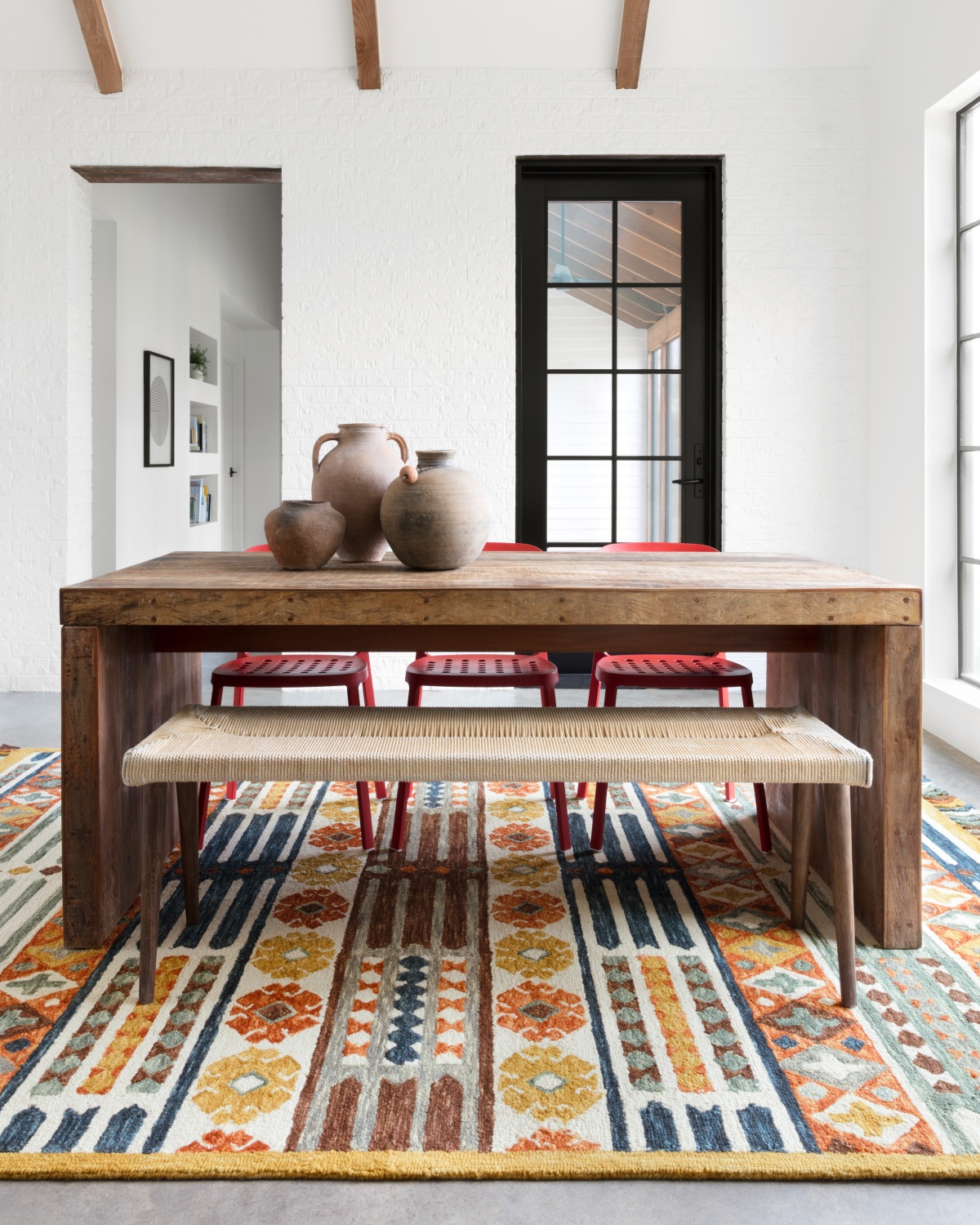 Wabi-sabi dining area with wood, ceramics, and woven art