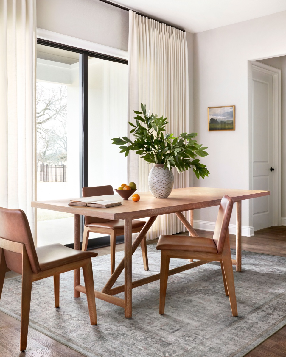 scandi-style dining room with white walls and wood tables and chairs